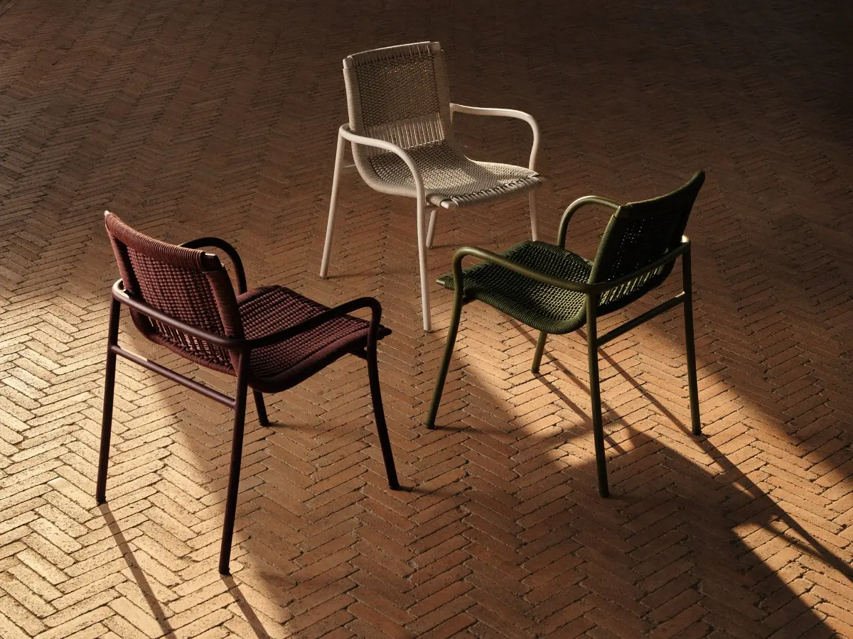 Betsy chairs in three colour variants in an outdoor setting.