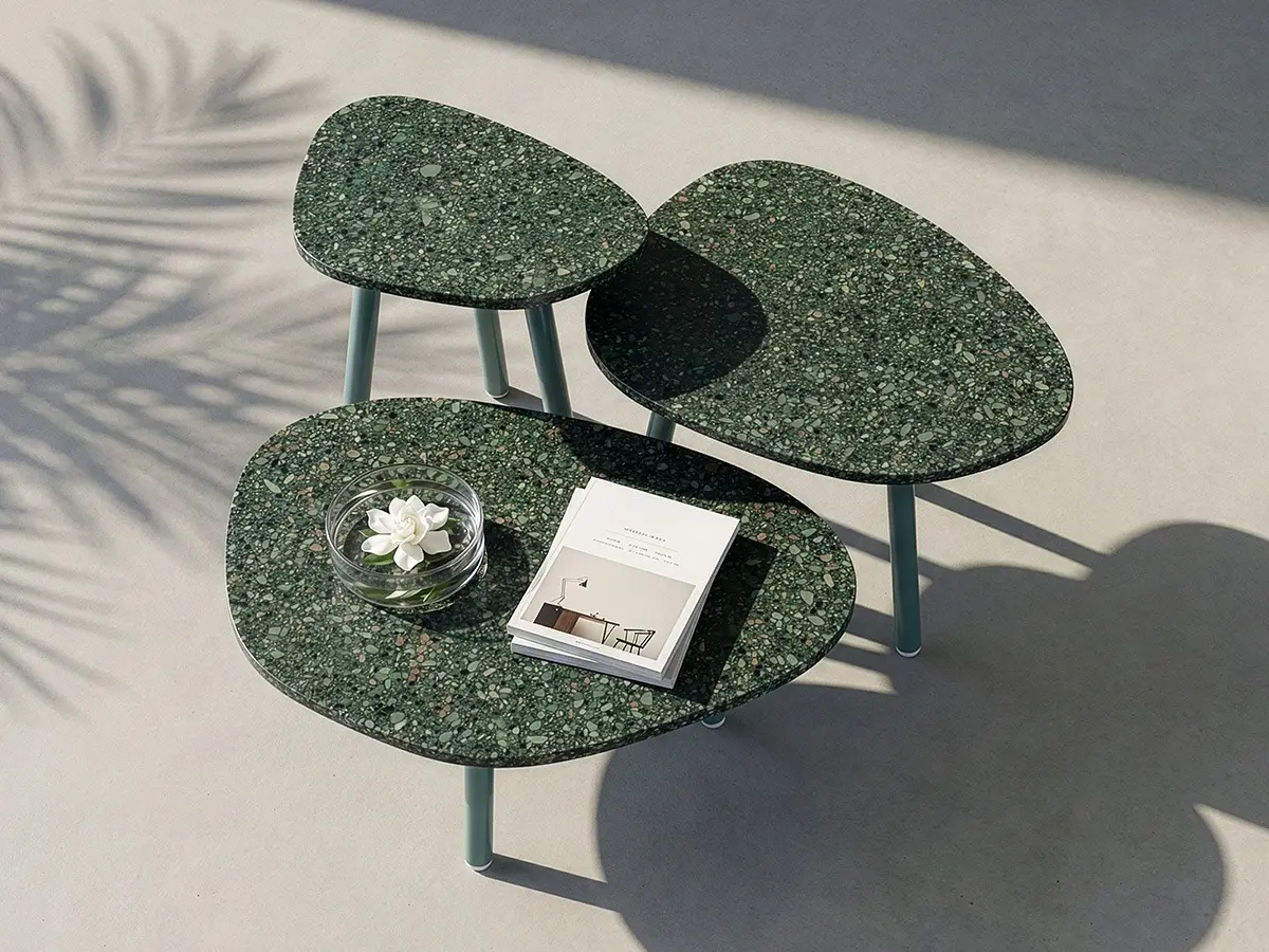 The beautiful terrazzo tabletops of the ISLA collection stands out against the white, concrete outdoor flooring. ISLA features three heights with different widths: the low coffee table, medium coffee table, and high coffee table.