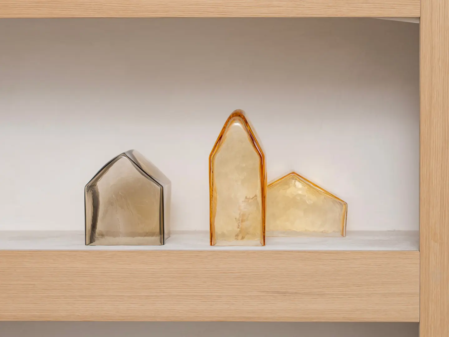 Mouth-blown glass sculpture from the Pagus collection by Studio Segers, shaped as a minimal rural building in warm tones.