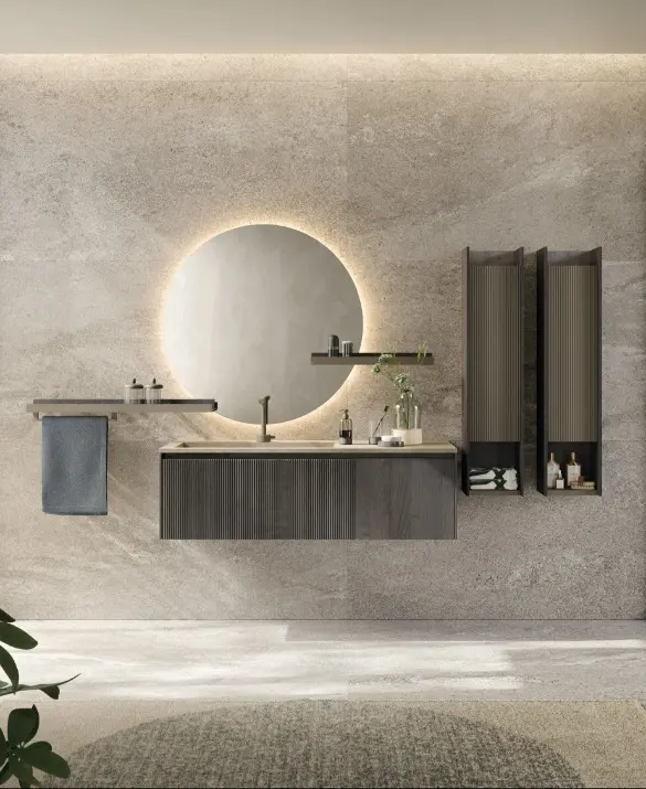 D'Art Bathroom. Wash-basin cabinet with plissé door and flat door in fumo oak, hanging cabinets with plissé door lava matt lacquered and structure in fumo oak, Fokos Roccia porcelain top, bicolor shelves in lava matt lacquer and fumo oak. Towel rail, round mirror with led lighting. 