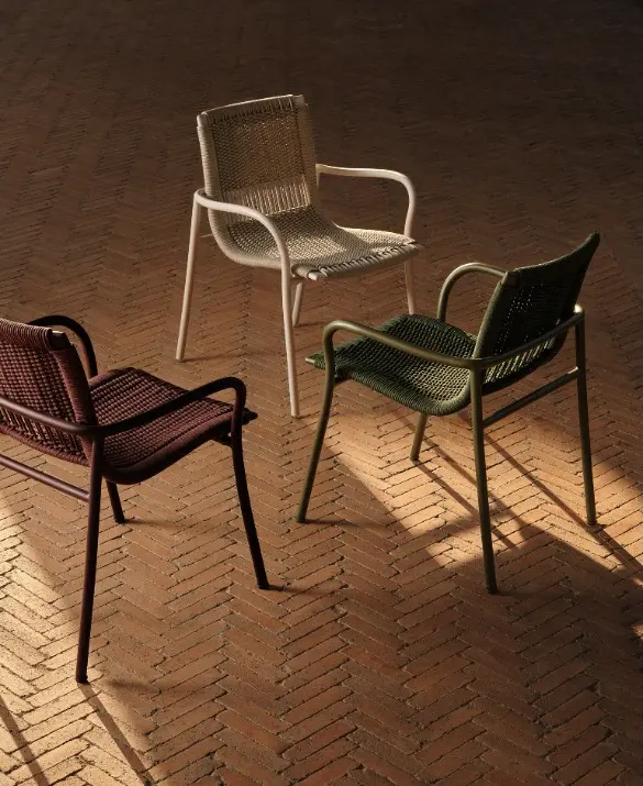 Betsy chairs in three colour variants in an outdoor setting.