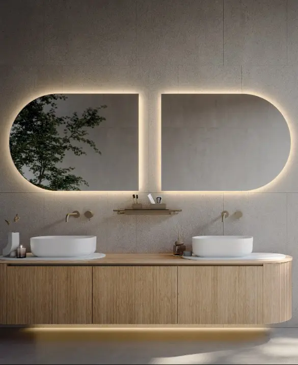 Bathroom Novello. Base units with “Elle” door and Rovere Naturale wood top, Titanium finish aluminum handle. Rounded side unit with pull-out drawer or with door and shelf . Oblon washbasin and tray in matte white Teknorit. Backlit mirror.