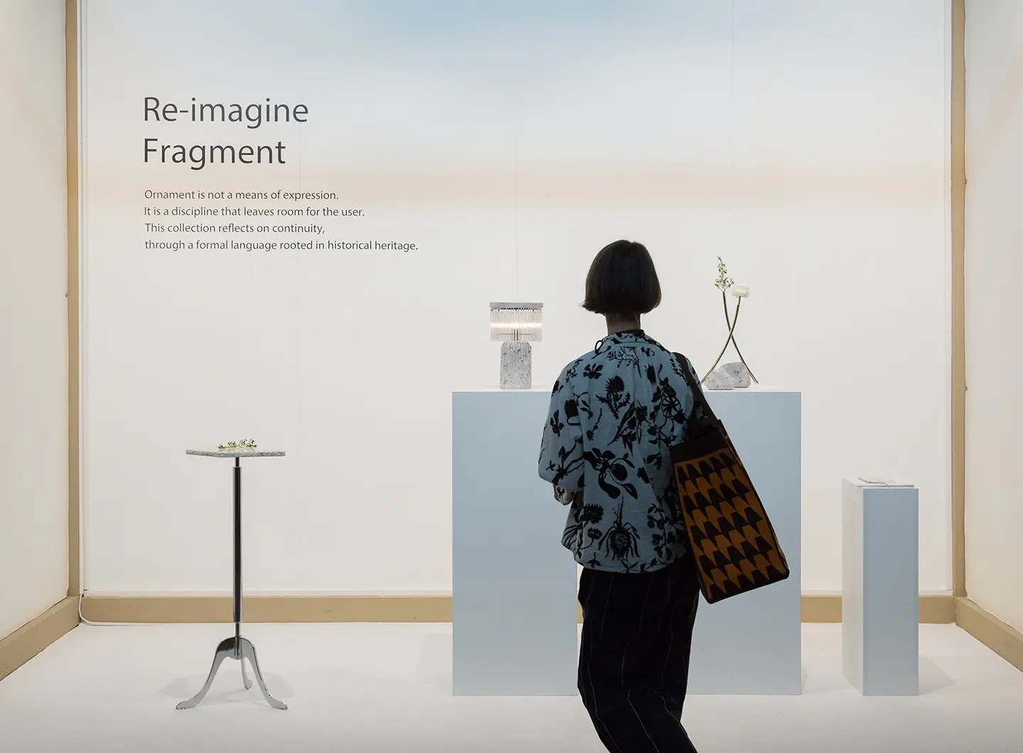 Woman looking at furnishing accessories made of marble and metal